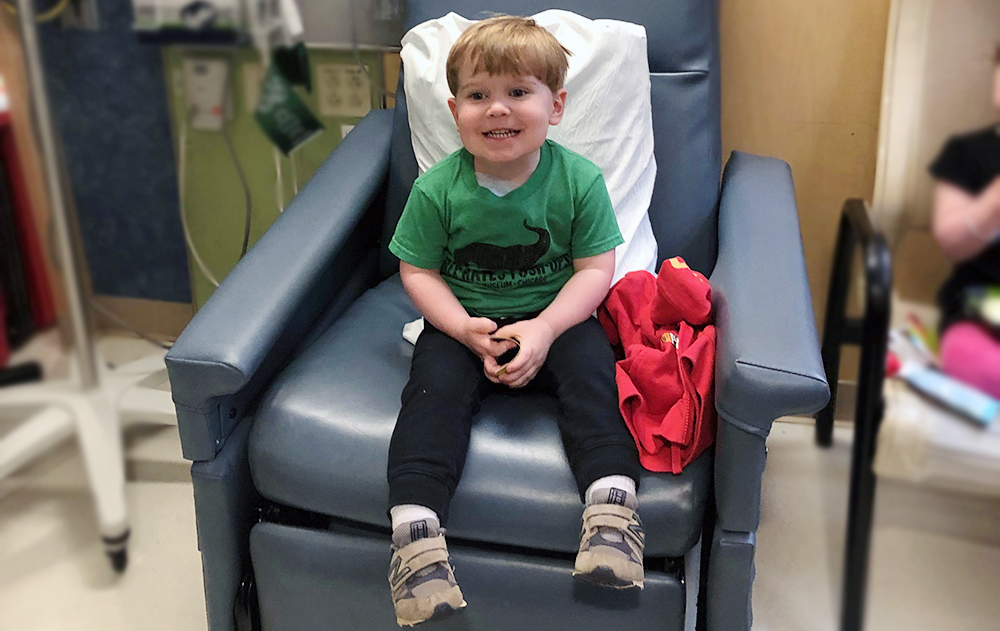 Young boy who is anxious sits in large chair