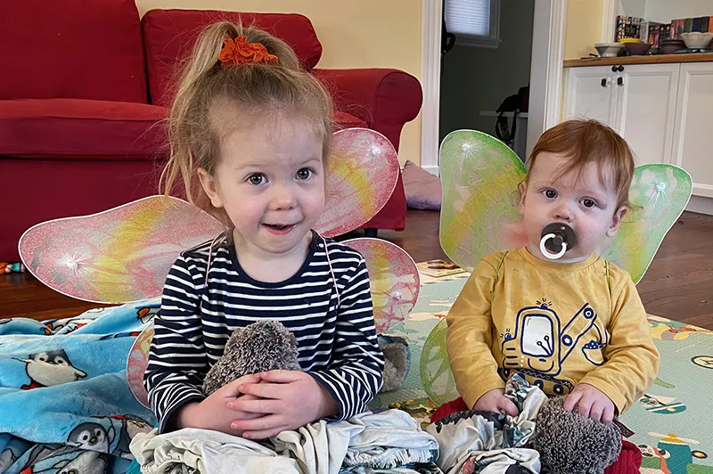 two childrens smiling at the camera